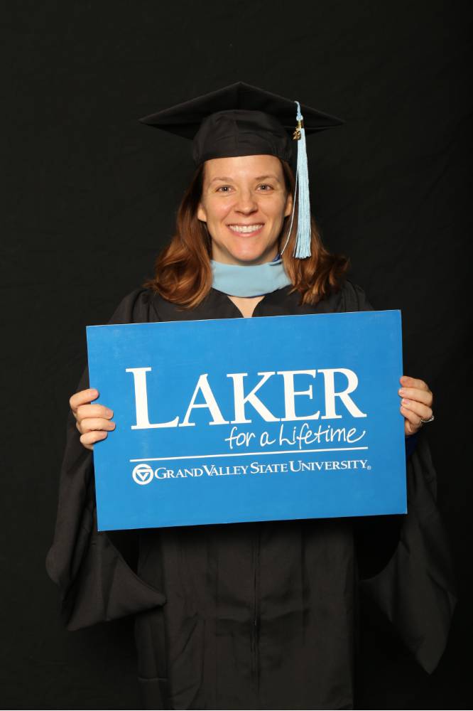 grad student with the laker for a lifetime gvsu flag